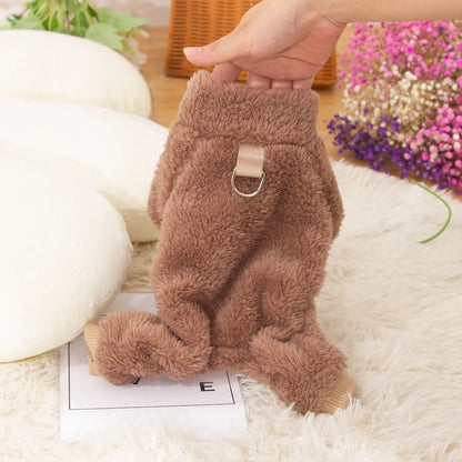 Blue double-sided plush four-legged dog clothing with high collar and towing ring laid flat.