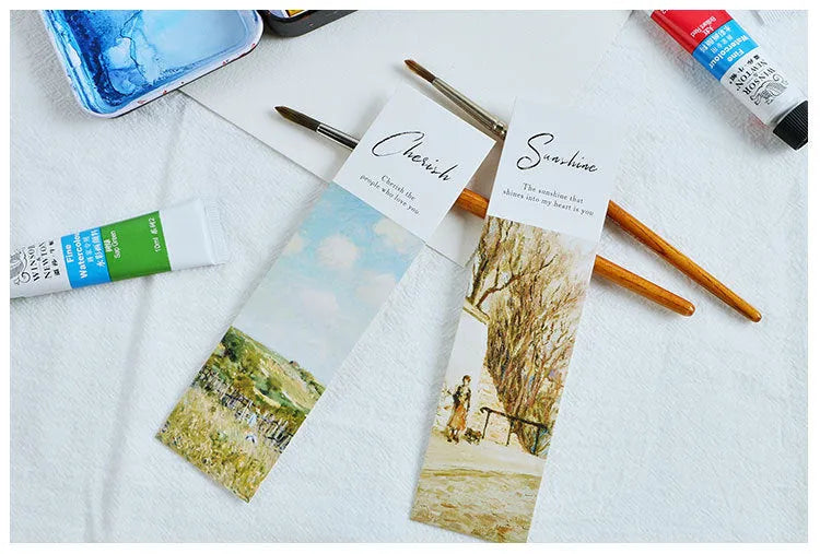 Pack of 30 white cardboard bookmarks with four artistic designs, measuring 40 by 150 millimetres.