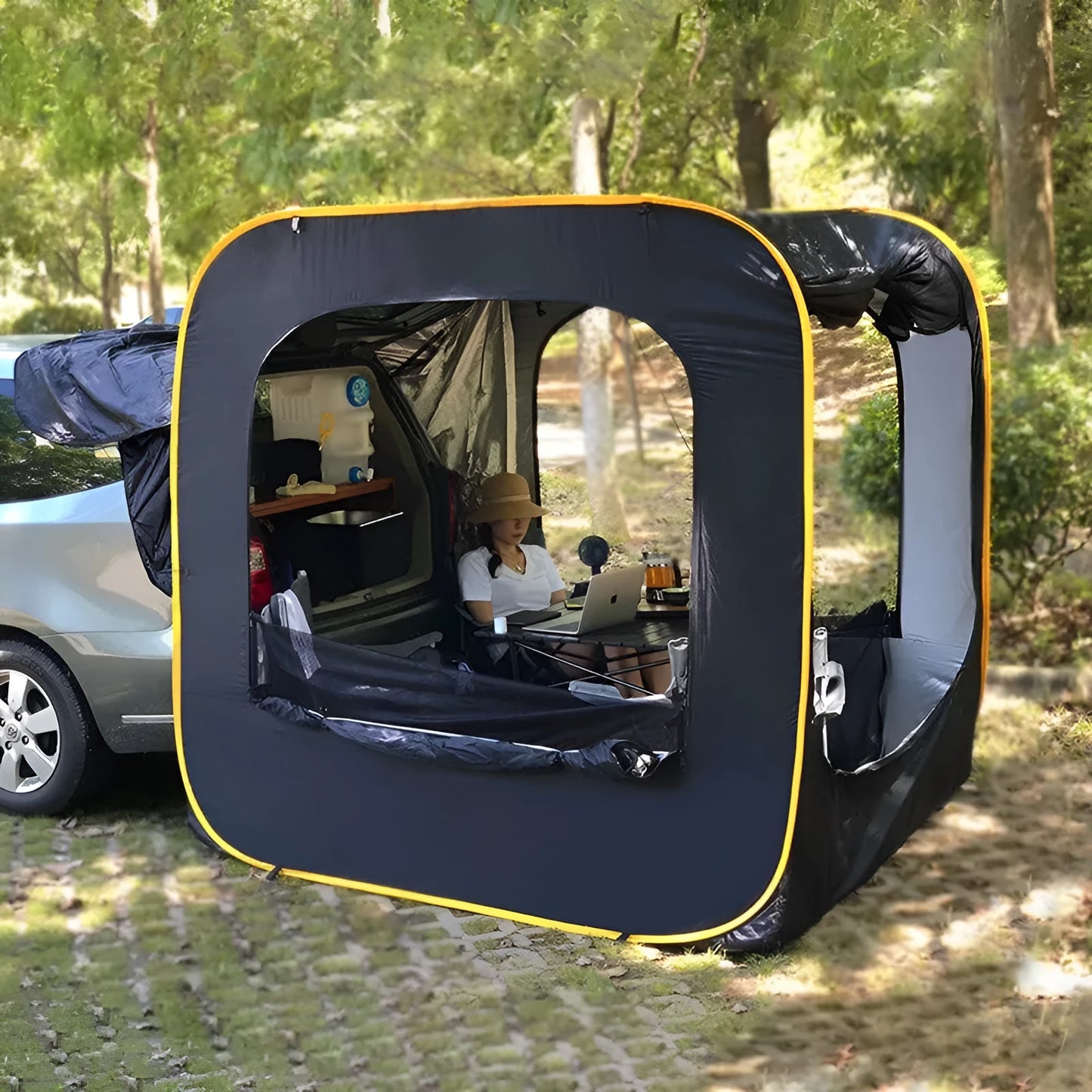 Black pop-up quick-throw car tail tent unfolded to a 200cm cube, set up behind an SUV.