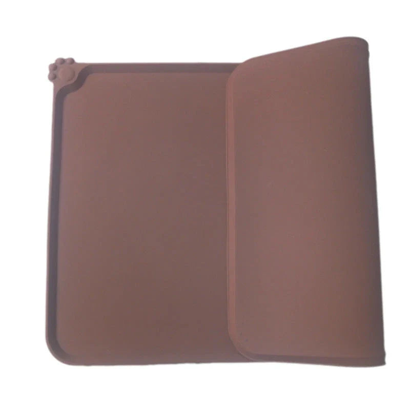 Silicone pet food mat with raised edges and non-slip base to contain messes and protect floors during pet mealtimes