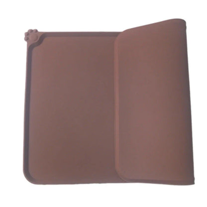 Silicone pet food mat with raised edges and non-slip base to contain messes and protect floors during pet mealtimes