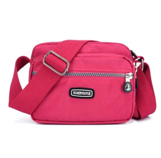 Compact nylon messenger bag in various colors with multiple compartments