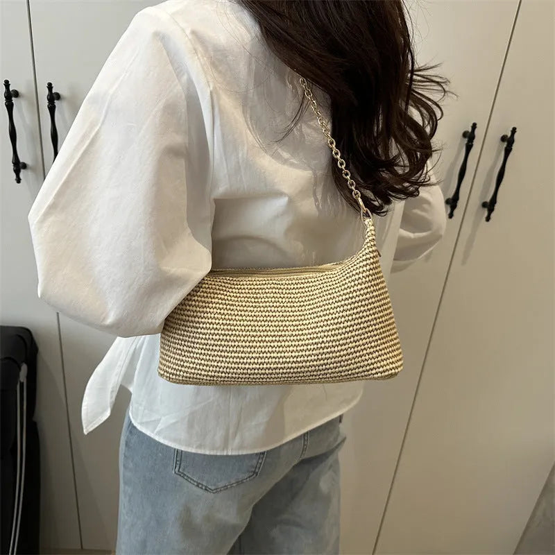 Woven straw shoulder tote bag in a horizontal square shape with a sandwich pocket.
