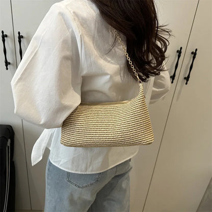 Woven straw shoulder tote bag in a horizontal square shape with a sandwich pocket.