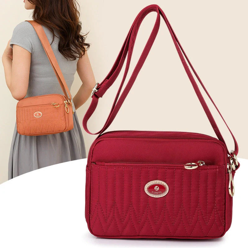 Casual women's crossbody messenger bag in nylon with polyester lining, available in multiple colors