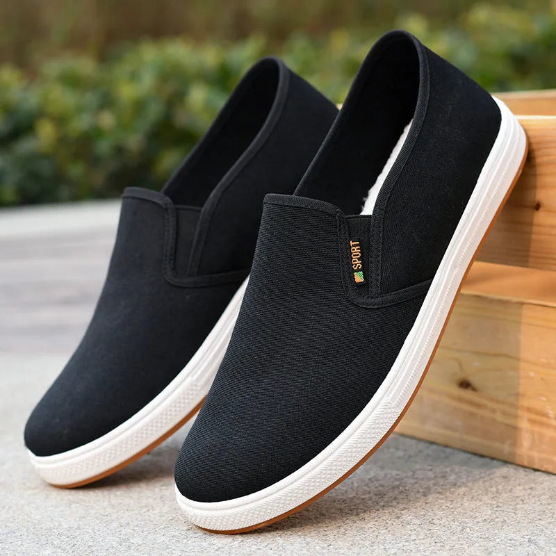 Men's low-top slip-on canvas casual shoes in black with a round toe and composite sole.