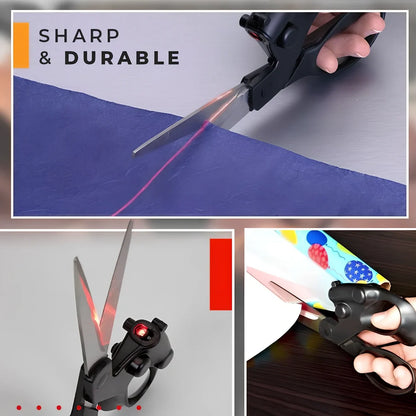 Black laser-guided scissors with red beam cutting straight line on wrapping paper