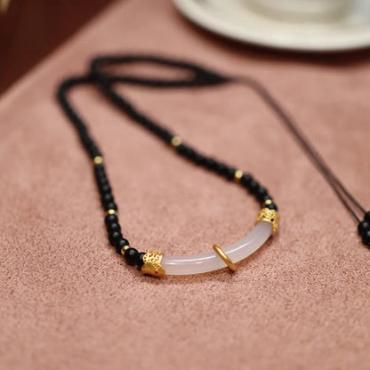 Women's Chinese style necklace with matte black agate pendant and silver ball bead chain.