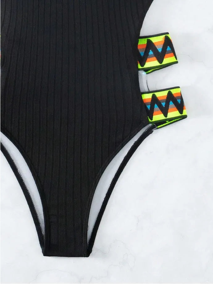 Women's solid colour one-piece swimsuit in black or orange options with polyester fabric construction