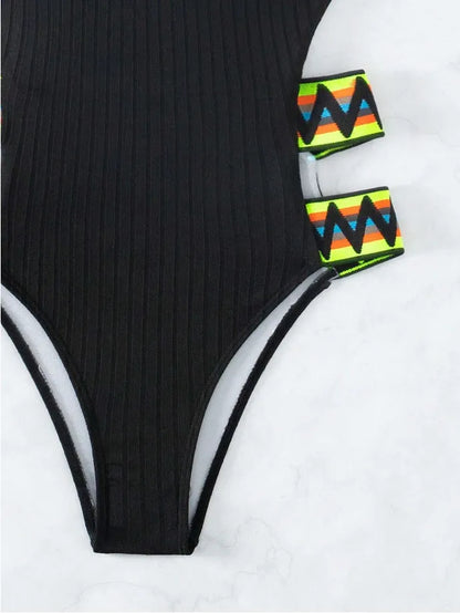 Women's solid colour one-piece swimsuit in black or orange options with polyester fabric construction