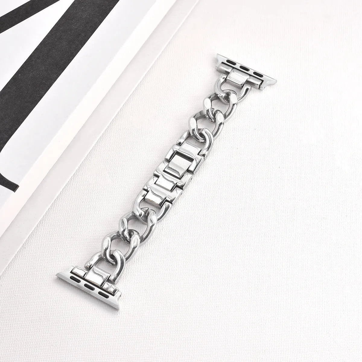 Silver metal link watch strap for Apple Watch with 22mm connectors on a grey background