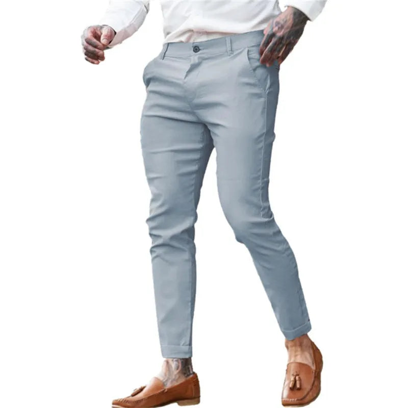 Men's slim fit elastic cotton pencil trousers in a solid colour on a hanger, showing the zip fly and mid waist design.
