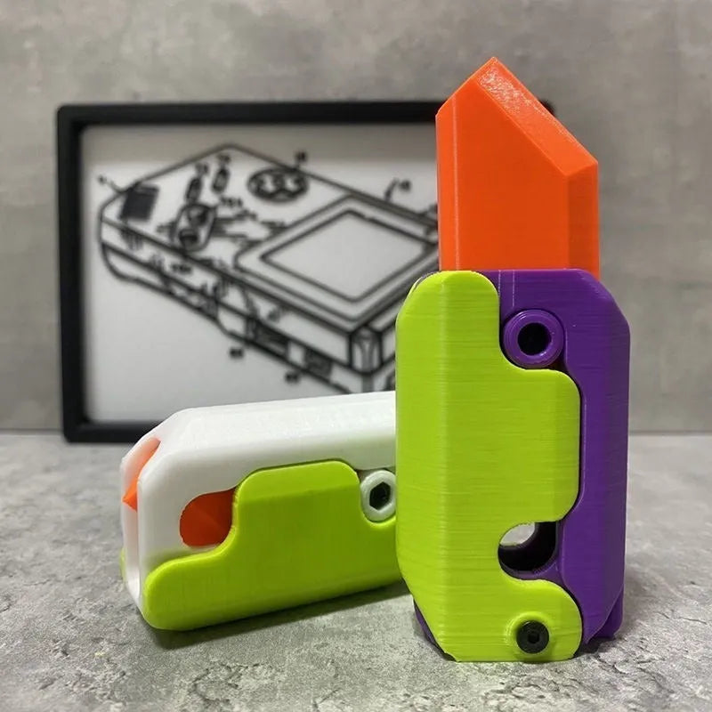 Small orange and green 3D printed plastic carrot knife fidget toy with blade extended.