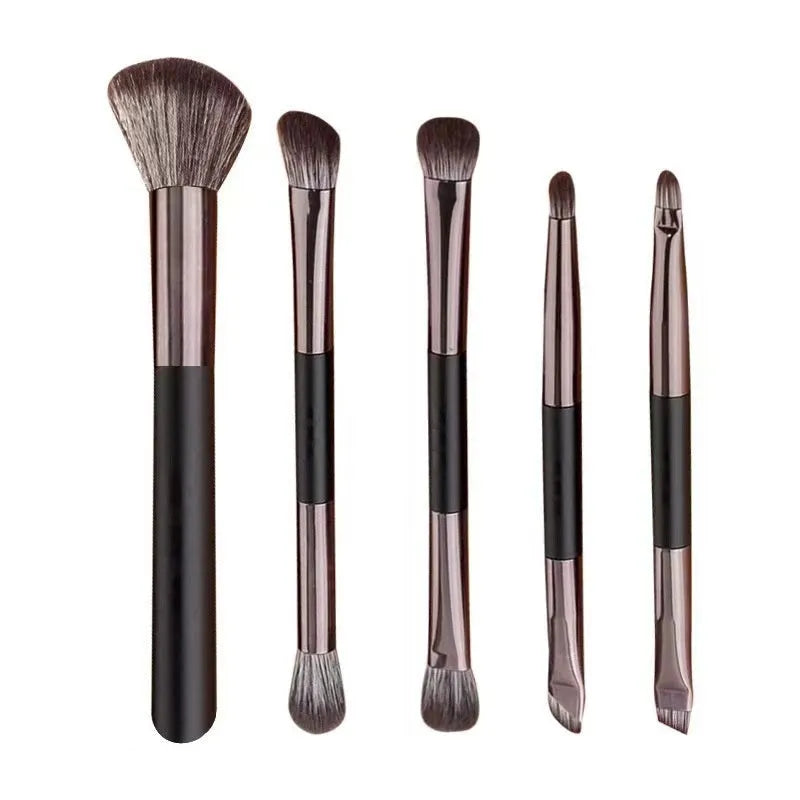 Makeup brush set with mirror compact case showing silver or gold brushes with artificial fibre bristles