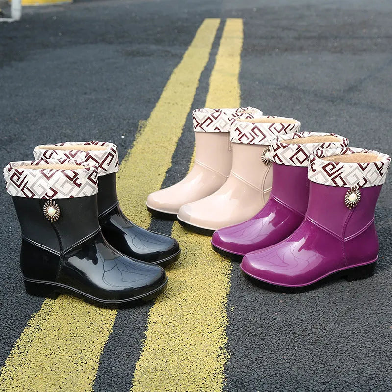 Women's purple PVC rain boot with non-slip sole on a wet surface.