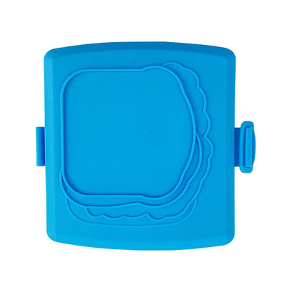 Red silicone baking tray with handbag-shaped mould and matching heat-resistant gloves on kitchen counter
