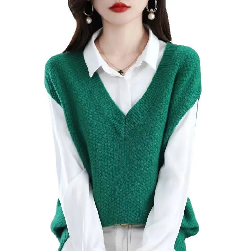Women's creamy-white sleeveless knit vest with a raised 3D pattern, shown on a hanger.