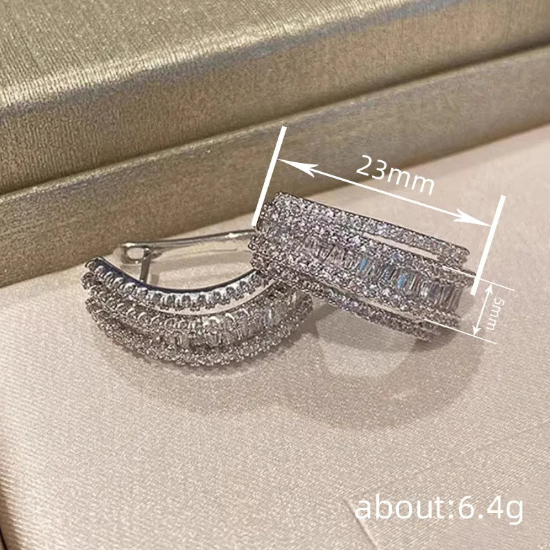 Women's white gold geometry stud earrings with inlaid zircon detail on copper.