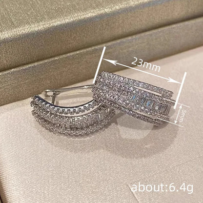Women's white gold geometry stud earrings with inlaid zircon detail on copper.