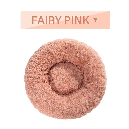 Fluffy donut-shaped dog bed in dark grey colour with raised edges, showing plush texture and circular design