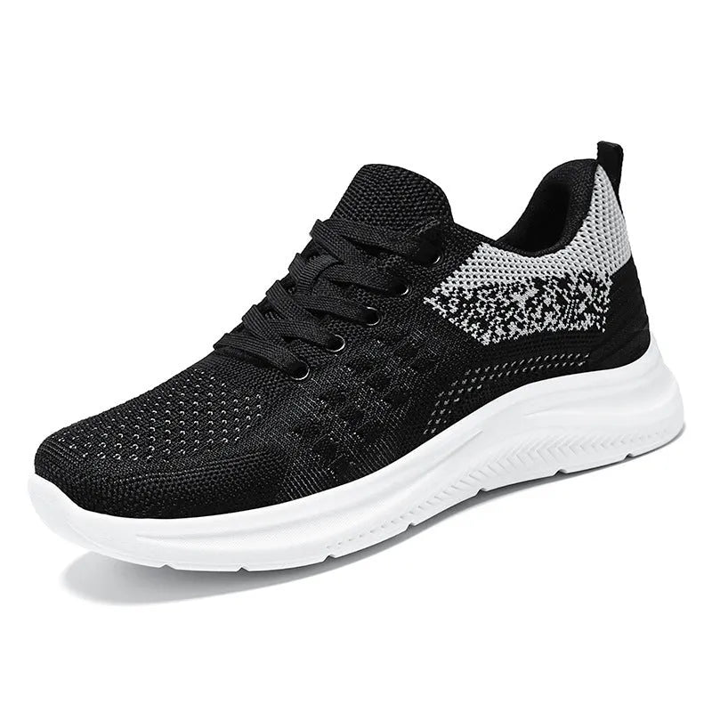 Women's black mesh sneakers with round toe and lace-up design showing breathable construction