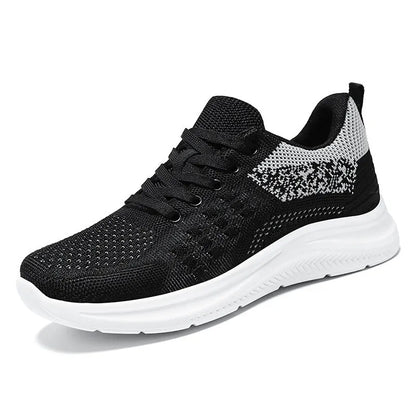 Women's black mesh sneakers with round toe and lace-up design showing breathable construction