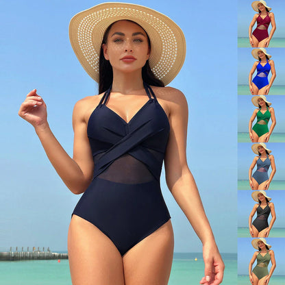 Halter one-piece swimsuit with cross-strap design, available in various solid colors and leopard print