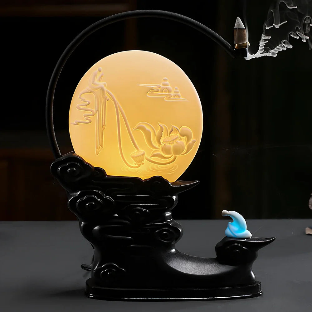 Purple sand tea pet backflow fragrance ornament with LED lighting creating cascading smoke effect