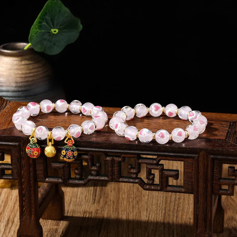 Handmade glass bracelet with 10mm swallowing gold beast cherry blossom heart charm in six colour options