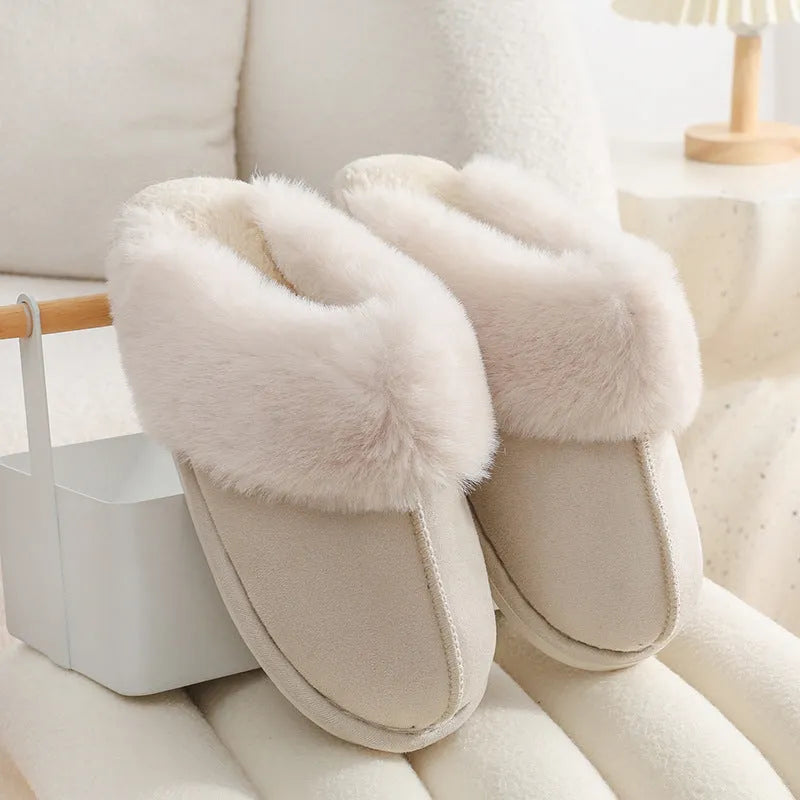 Women's plush indoor slippers in a selection of colours with a fuzzy upper and flat sole.