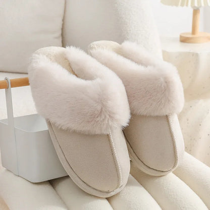 Women's plush indoor slippers in a selection of colours with a fuzzy upper and flat sole.