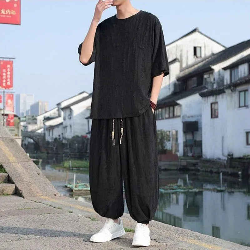 Men's black and grey knitted short-sleeve top with matching loose cropped trousers casual suit set