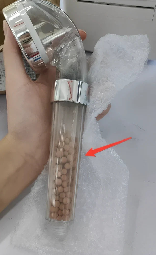 Pressurised shower head with stainless steel panel showing three water mode settings and removable nozzles