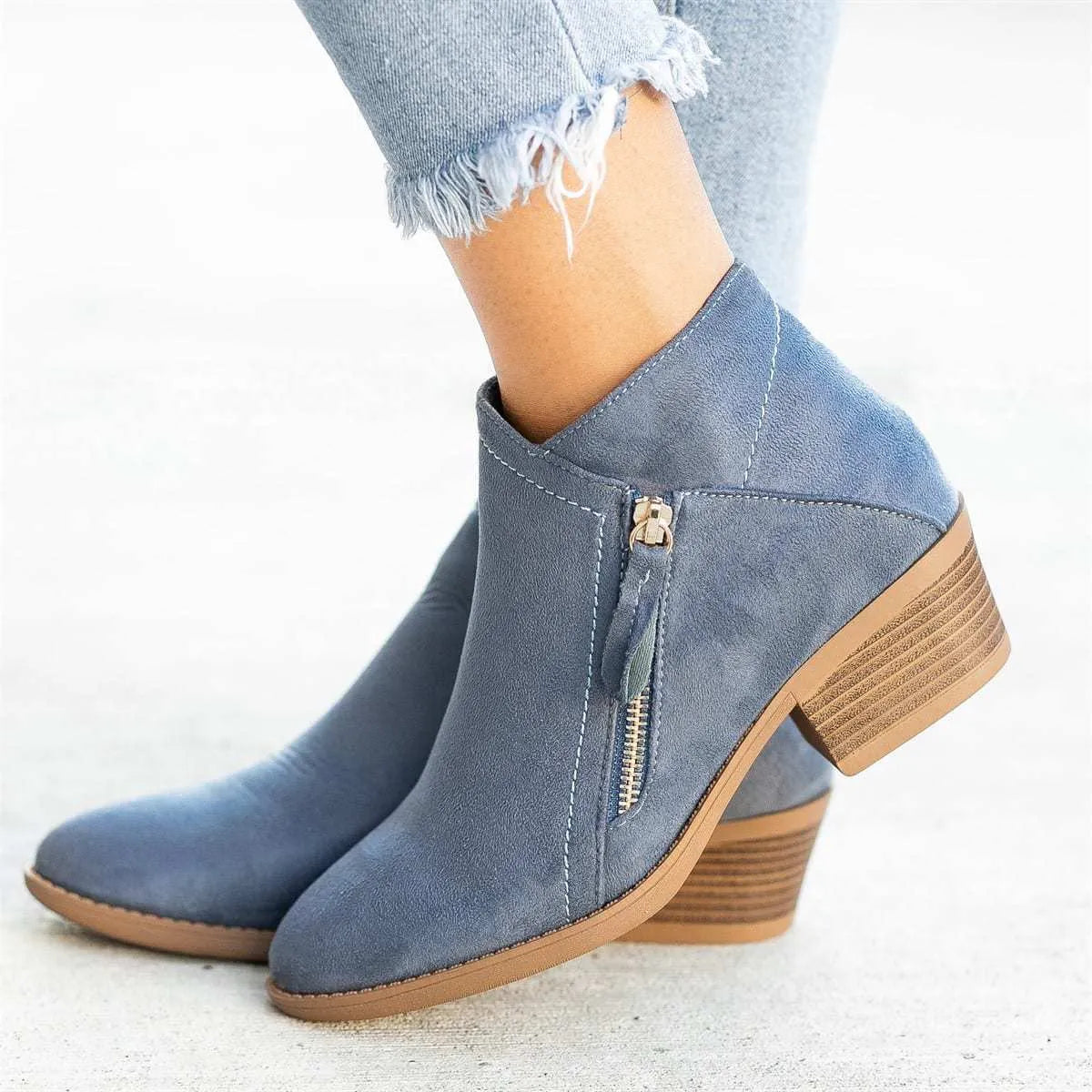 Women's blue suede Dr Martens ankle boots with side zip and chunky heel.