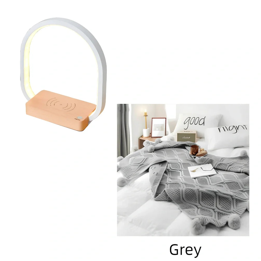 White wireless charging table lamp with metal shade and button switch on wooden surface
