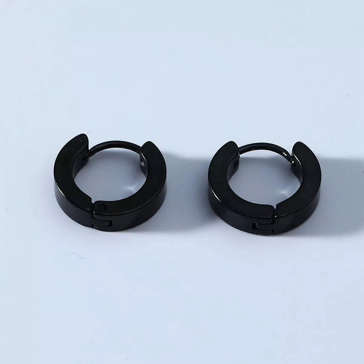 Black stainless steel geometric circle earrings for men, durable and stylish design