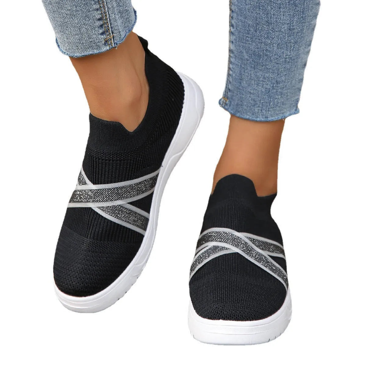 Black women's flyknit mesh flat shoes with rubber sole and tassel detail