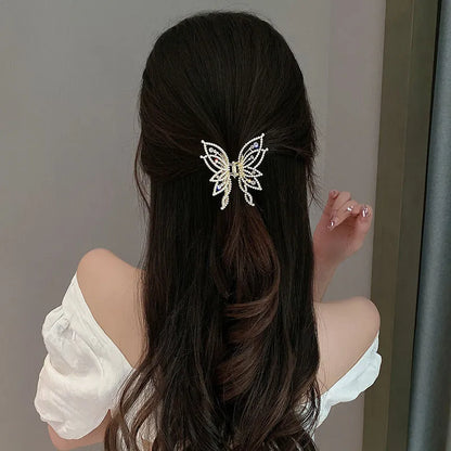 Butterfly-shaped alloy hair clip for women, available in rhinestone or pearl style.