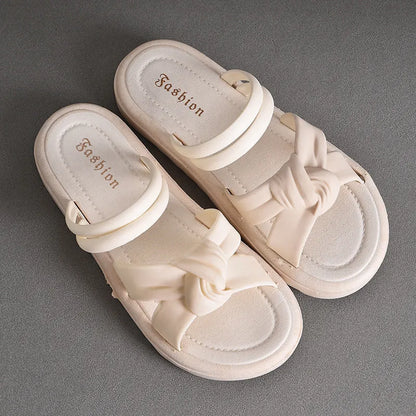 Women's black PVC sandals with thick soft back, floral detail, and injection moulded sole