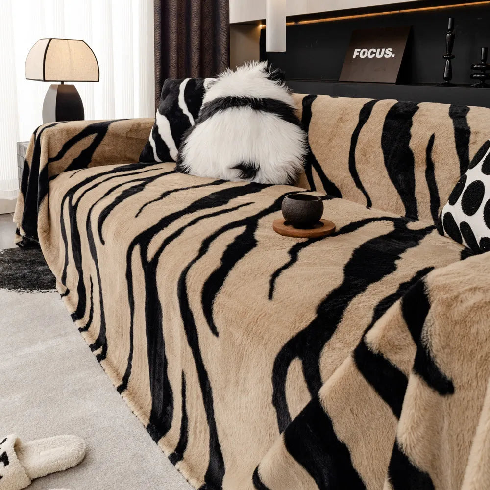 Zebra pattern sofa cover cloth in flannel fabric with non-slip backing, shown in caramel colour on a sofa