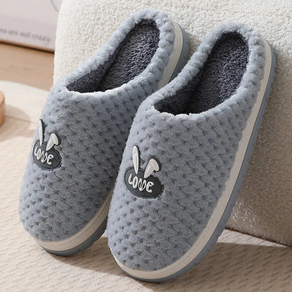 Women's plush rabbit plaid design winter slippers with a thick light-coloured rubber sole.