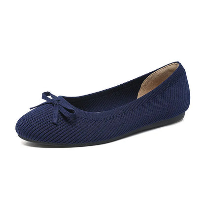 Women's black fabric flat pumps with a bow detail on the round toe, shown on a white background.