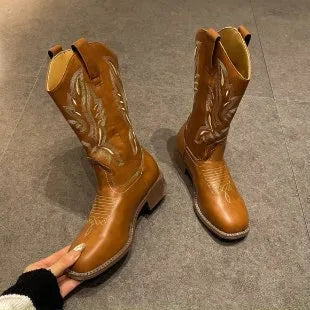 Brown women's mid-calf Martin boots with embroidered detail on the shaft.