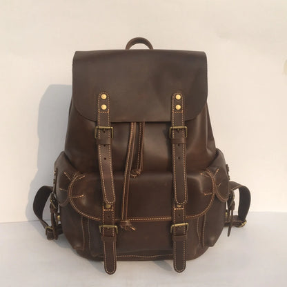 Men's brown leather backpack showing cowhide texture and air pillow belt system