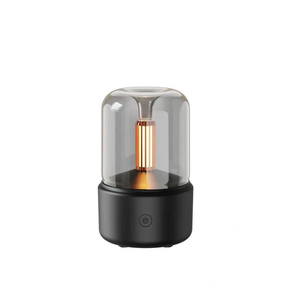 Compact black aroma diffuser humidifier with remote control on wooden surface