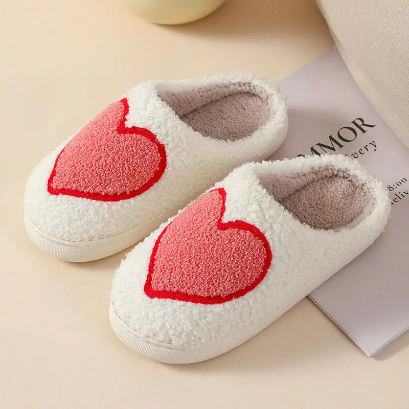 Women's plush home slippers in cartoon designs with a non-slip PVC sole.