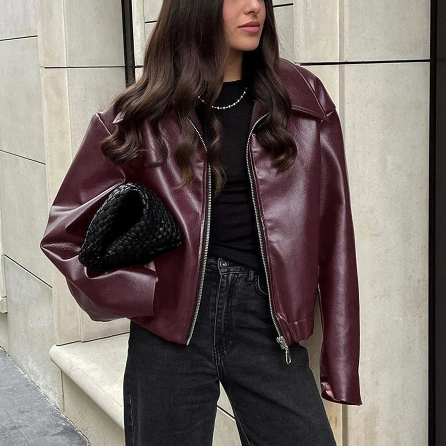 Stylish faux leather jacket with zip-up closure and lapel collar, available in burgundy and black colors