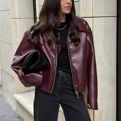 Stylish faux leather jacket with zip-up closure and lapel collar, available in burgundy and black colors