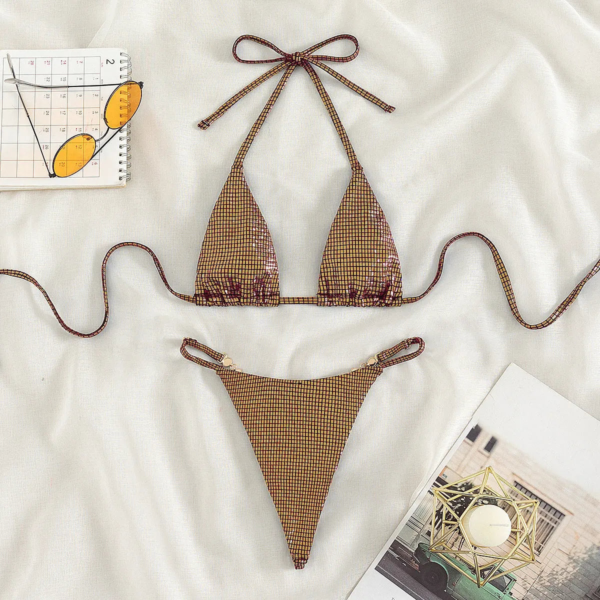 Solid blue women's T-back bikini set laid flat, showing bra and briefs.