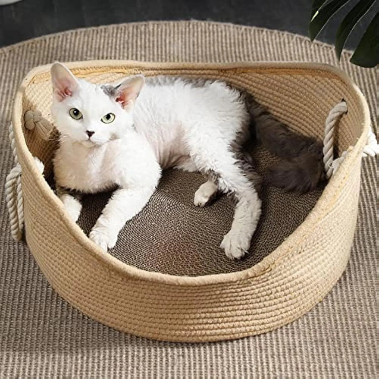 Natural wicker cat basket with integrated corrugated cardboard scratching panel side.